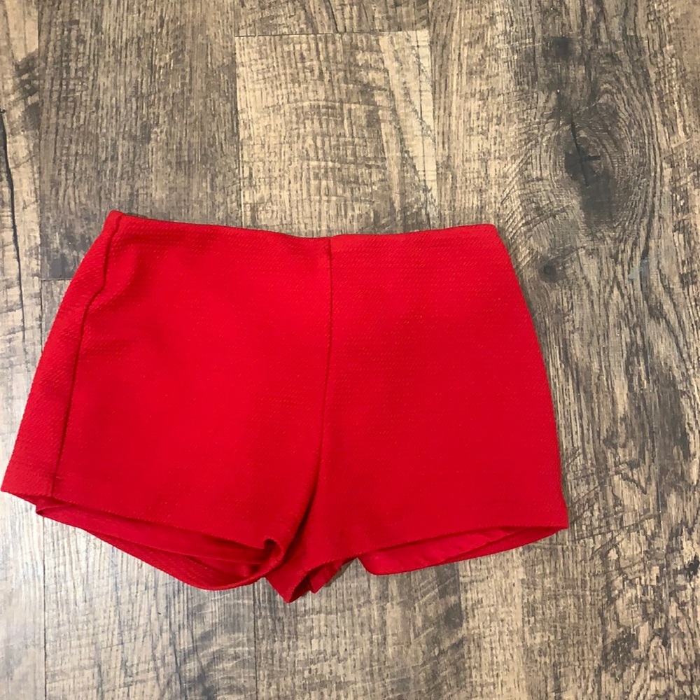 Red textured shorts.